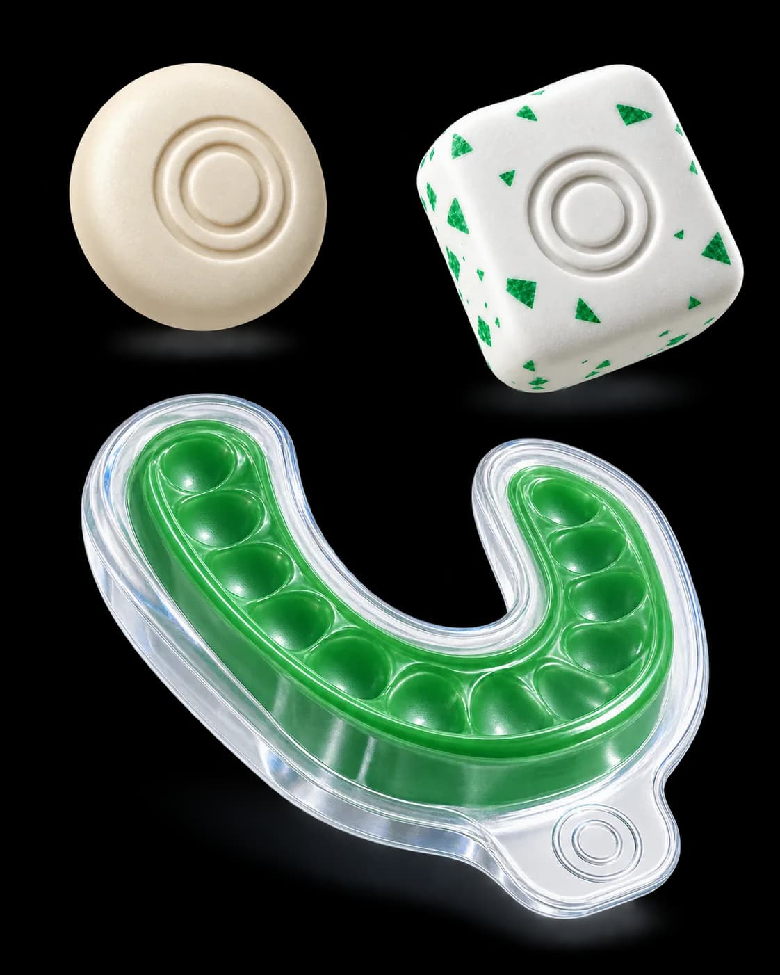 A green whitening tray in a clear case floating below a round ivory mint and a white gum piece with green flecks